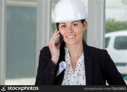 portrait of a happy woman engineer on the phone