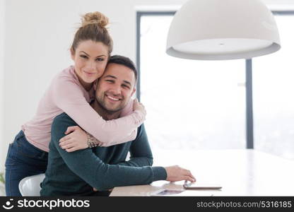 Portrait of a happy young beautiful couple hugging in their new home