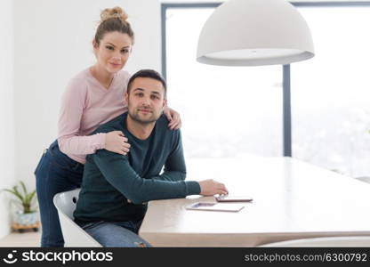 Portrait of a happy young beautiful couple hugging in their new home