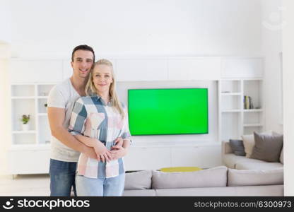 Portrait of a happy young beautiful couple hugging in their new home