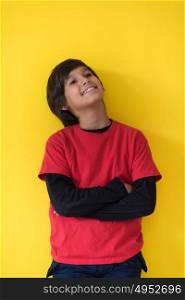 Portrait of a happy young boy in front of colored background