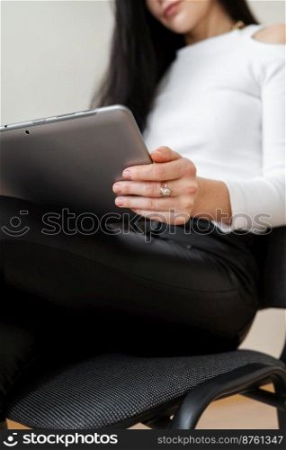 Portrait of a happy young business woman using a tablet working outside the office. Modern technologies and business. Portrait of a happy young business woman using a tablet working outside the office. Modern technologies and business.