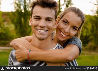 Portrait of a happy young couple embraced together