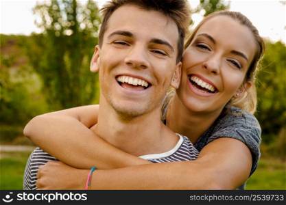 Portrait of a happy young couple embraced together