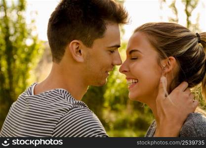 Portrait of a happy young couple in love and giving a kiss