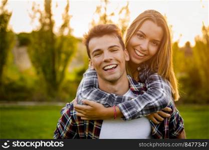 Portrait of a happy young couple in the nature hugged together