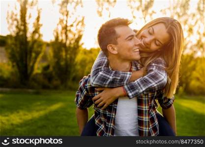 Portrait of a happy young couple in the nature hugged together