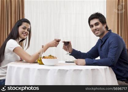 Portrait of a happy young couple on a date at restaurant