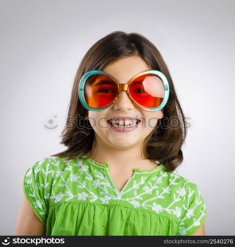 Portrait of a happy young girl wearing funny sunglasses