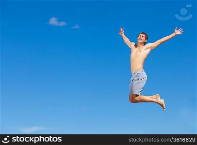 Portrait of a happy young man having fun on the beach on a summer vacation.