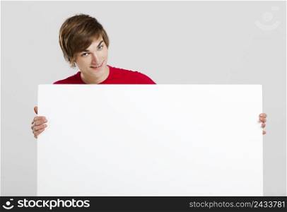 Portrait of a happy young man holding blank white card