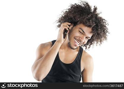 Portrait of a happy young man listening to mobile phone over white background