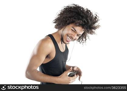 Portrait of a happy young man with mp3 player over white background