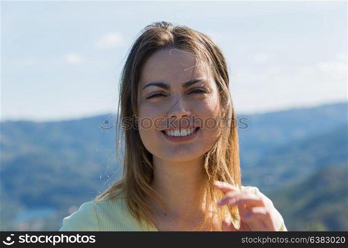Portrait of a happy young woman, outdoor.