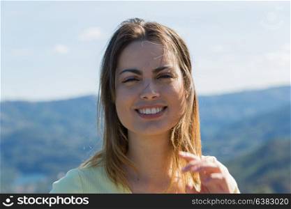 Portrait of a happy young woman, outdoor.