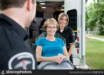 Portrait of a healthy senior citizen on an ambulance stretcher