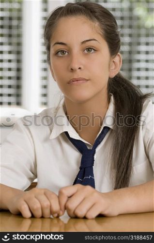 Portrait of a high school student sitting in a classroom