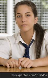 Portrait of a high school student sitting in a classroom