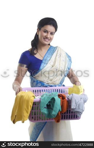 Portrait of a housewife holding a laundry basket
