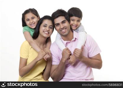 Portrait of a Indian family smiling over white background