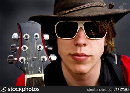 Portrait of a jazz rock guitarist wearing an old hat