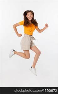Portrait of a joyful woman jumping in the studio with happy feeling, isolated on white background, 20-28 year old. Portrait of a joyful woman jumping in the studio with happy feeling, isolated on white background, 20-28 year old.