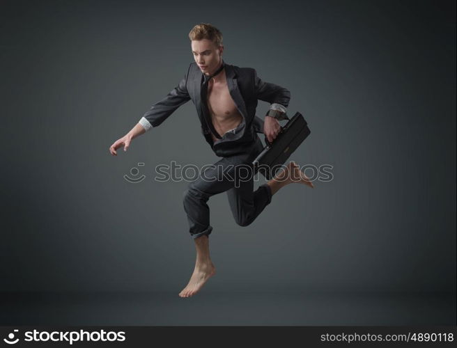 Portrait of a jumping muscular employee