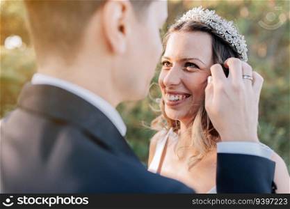 Portrait of a just married couple about to kiss on a forest