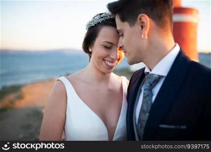 Portrait of a just married couple against the ocean