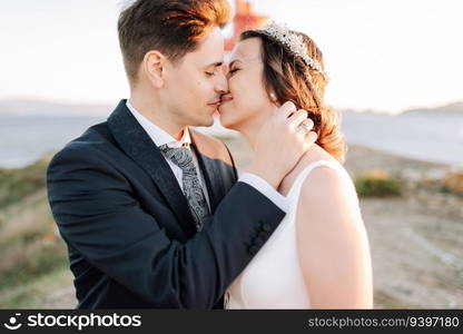 Portrait of a just married couple kissing against nature