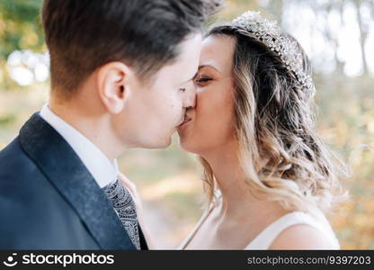 Portrait of a just married couple kissing in the woods