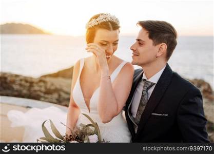 Portrait of a just married couple with the bride crying and smiling