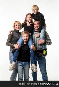 Portrait of a large family with teenagers in casual clothes on a white background a. Portrait of a large family with teenagers in casual clothes on a white background