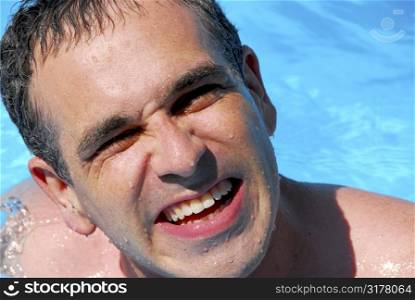 Portrait of a laughing man in a swimming pool