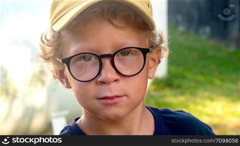 portrait of a little blond boy with glasses