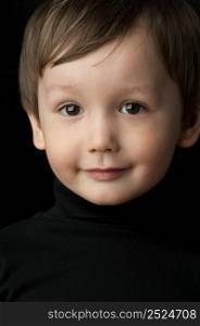 portrait of a little boy on a dark background. portrait of a little boy