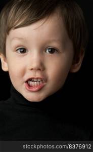 portrait of a little boy on a dark background. portrait of a little boy