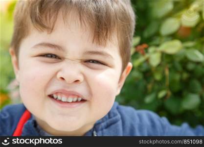 portrait of a little boy outdoors in the warm season
