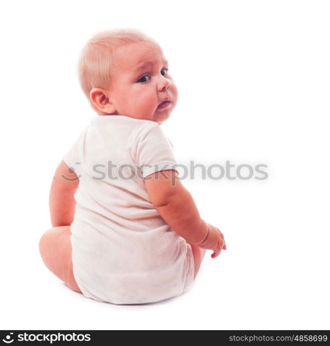 Portrait of a little boy that sitting and looking at camera over shoulder, isolated on white background