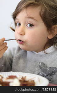 Portrait of a little girl eating