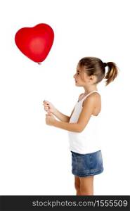 Portrait of a little girl holding and looking to a red balloon, isolated on white background