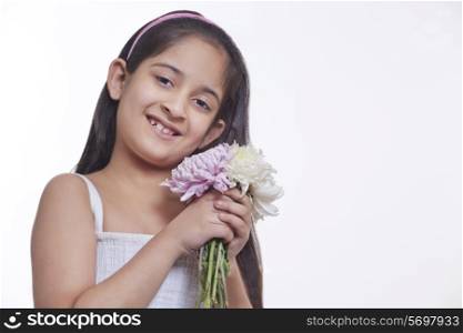 Portrait of a little girl holding flowers