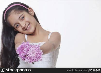 Portrait of a little girl holding flowers