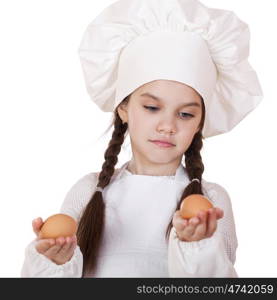 Portrait of a little girl in a white apron holding two chicken eggs, isolated on white background
