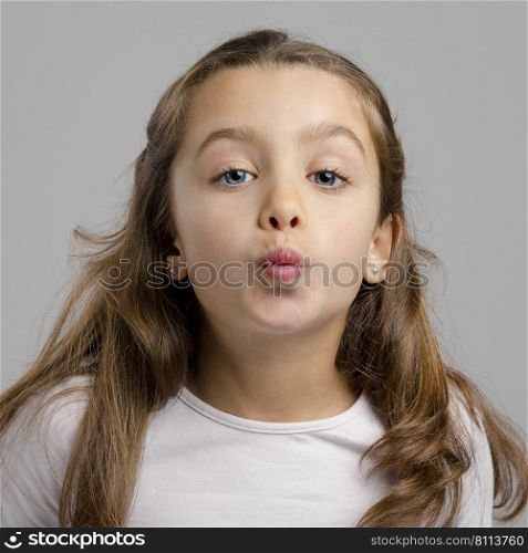 Portrait of a little girl sending a kiss