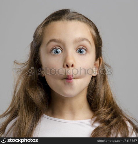 Portrait of a little girl with a funny expression