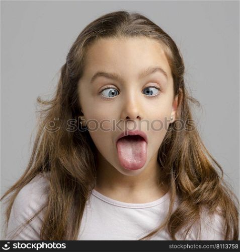Portrait of a little girl with a funny expression