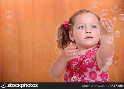 portrait of a little girl with bubbles