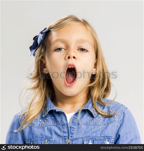 Portrait of a little girl with her mouth open