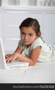 portrait of a little girl with laptop